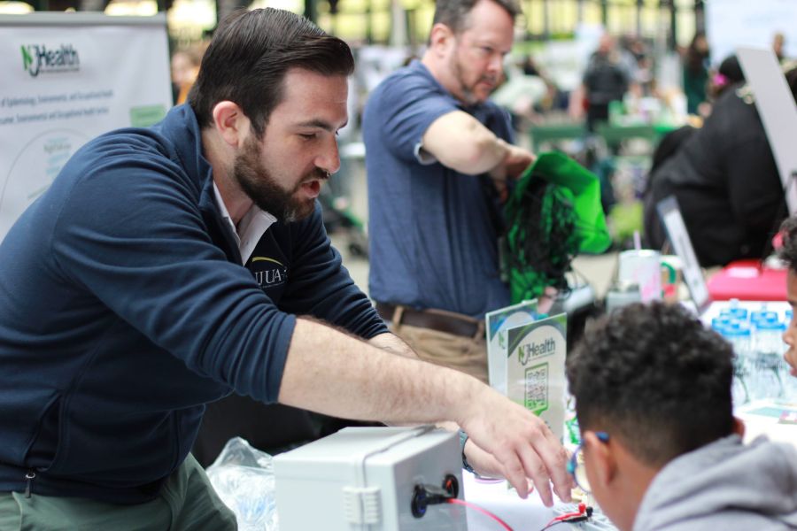 NJUA External Affairs Director Joey Gurrentz explains electricity to a young attendee